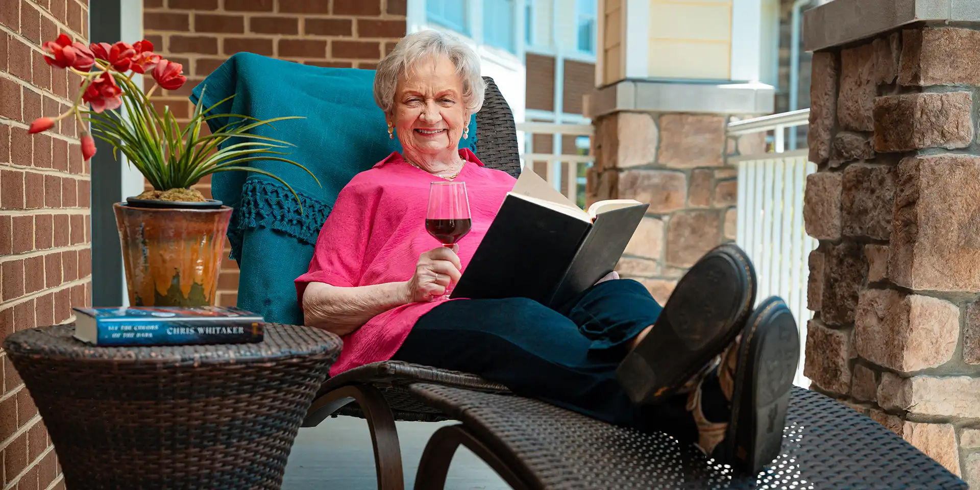 Covenant Woods resident enjoying time on the Lodge apartment balcony