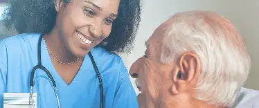 A nurse and a smiling elderly lady