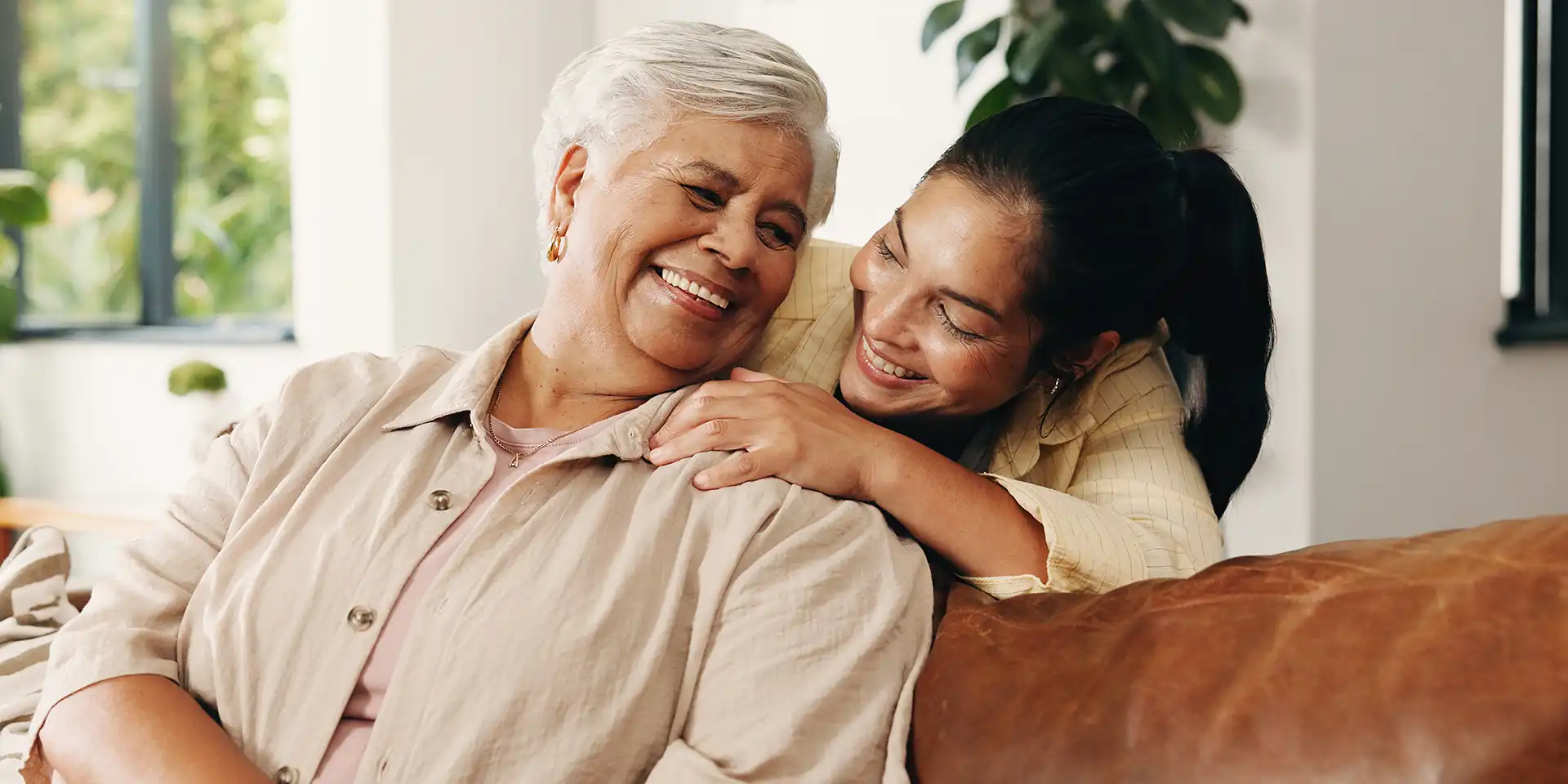 CW-26-011-09-1928854056 Senior with adult child embracing on a couch